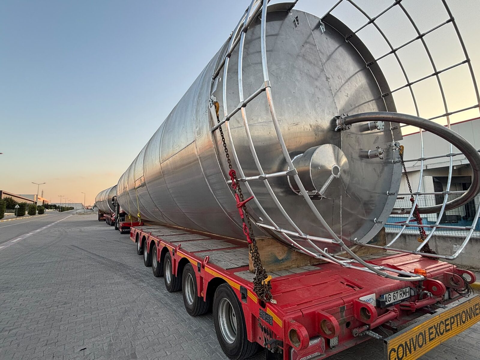 The large-scale stainless vertical mixer body seen during transport