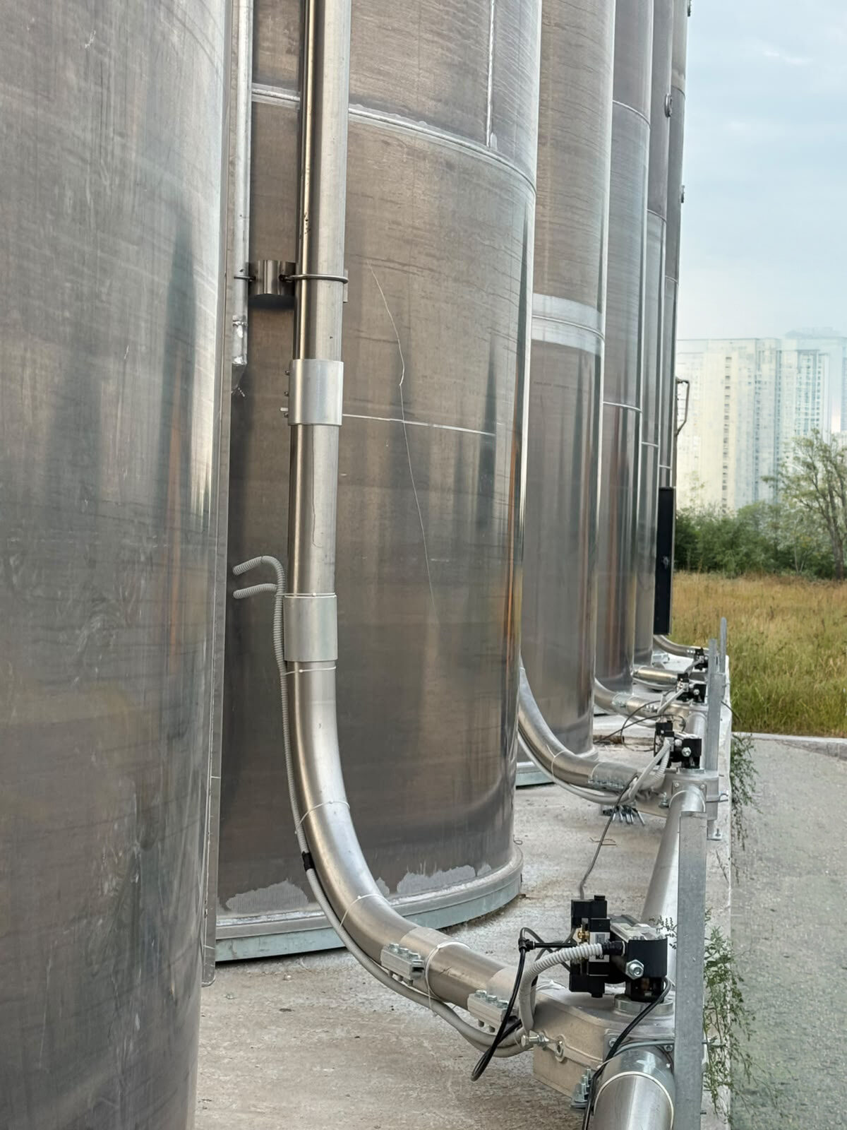 The stainless discharge and valve group at the silo base