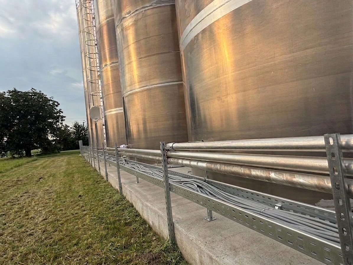 Stainless base feeding lines running along the silo group